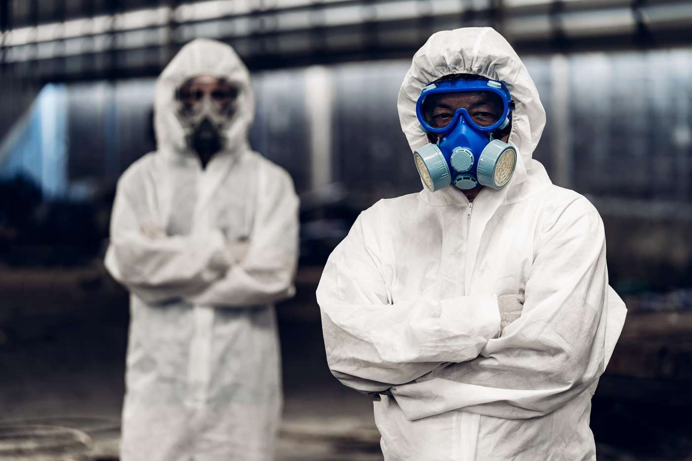 Netpower-logo-white@4x two men in chemical protection suits